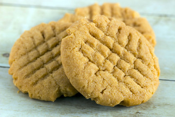 Homemade peanut butter cookies on light wood background