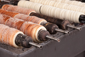 Trdelnik - traditional Czech hot sweet pastry baked on a stick and sold in the streets of Prague