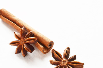 anise stars with cinnamon stick background