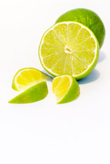 whole lime half lime and lime slices over white background with copy space