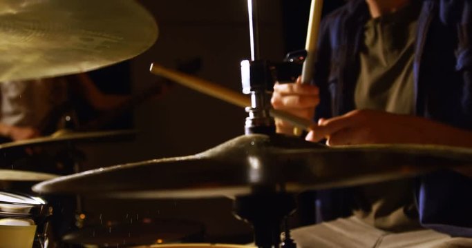 Drummer playing drum in studio