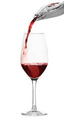 Pouring red wine into glass on white background