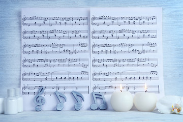 Composition of music sheets and spa supplies on table