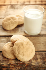 Tasty sugar cookies with glass of milk on table