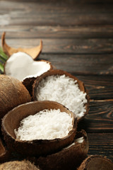 Grated coconut in shell on wooden background