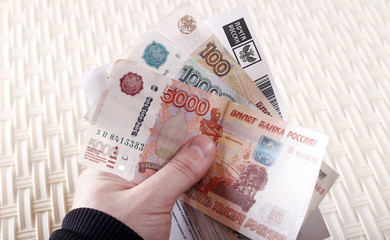 A man holds money and a receipt