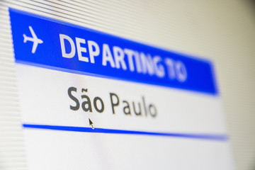 Computer screen close-up of status of flight departing to Sao Paulo, Brasil