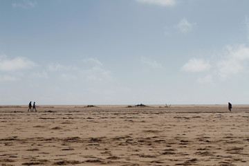 Fototapeta na wymiar Three people on beach on Portuguese Island, Mozambique