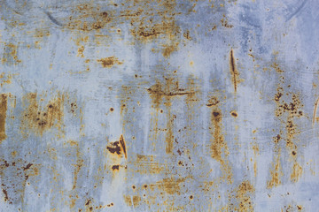 Rusted painted metal wall corrosion with streaks of rust