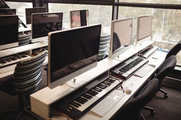 Desktop computers and pianos arranged on desk in office