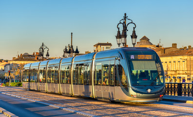 City tram on Pont de Pierre bridge in Bordeaux, France - obrazy, fototapety, plakaty