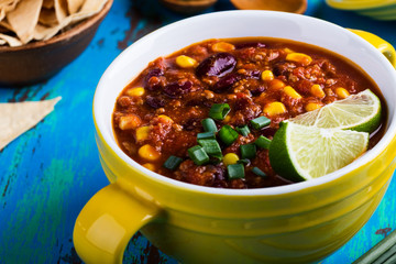 Chili con carne stew served in yellow bowl