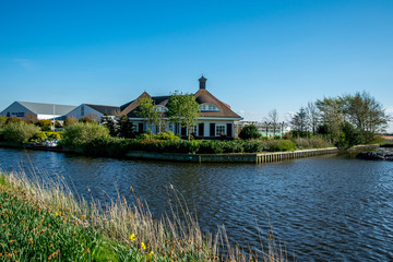 Fototapeta premium green landscape view with grass water and blue sky