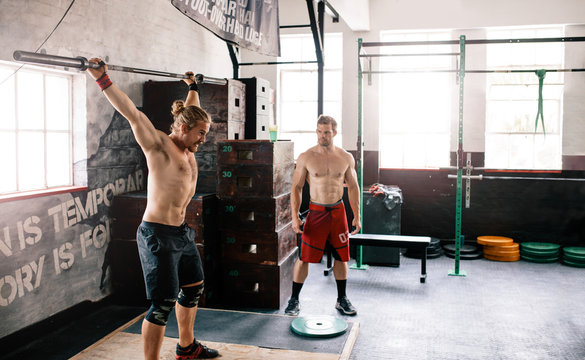 Two male athlete exercising at the gym