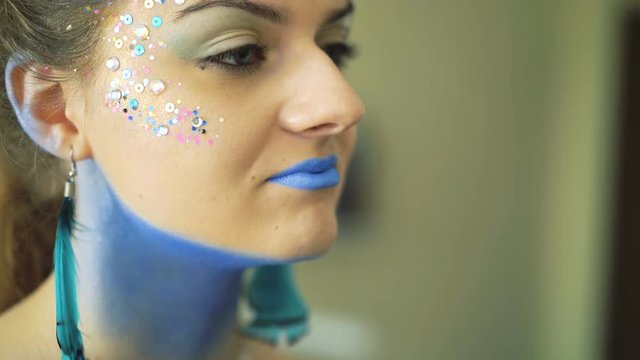 The girl with bodyart of peahen makeup for carnival and halloween 4K
