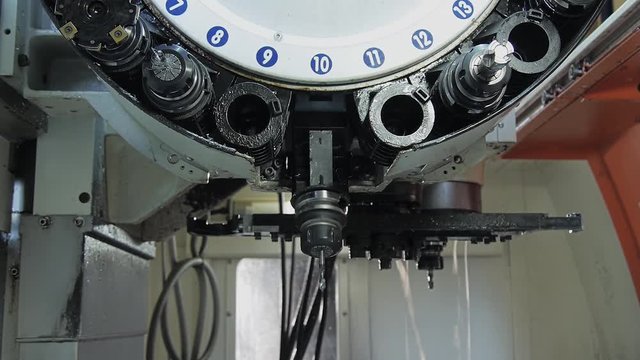 Milling machine in action. Change of cutters.