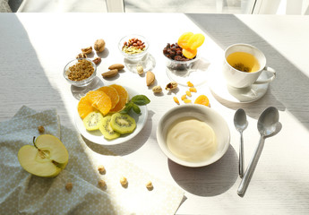 Composition with tasty yogurt on kitchen table