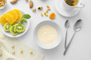 Composition with tasty yogurt on kitchen table