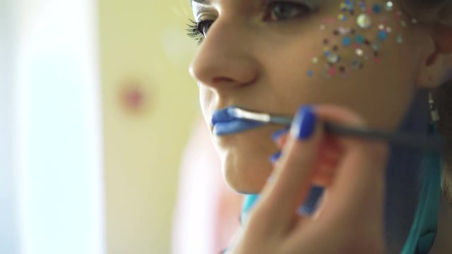 Make-up artist making bodyart of peahen for carnival and halloween for girl 4K