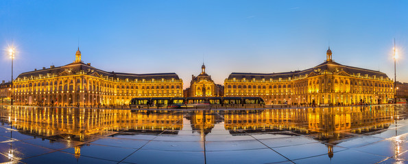 Iconic panorama of Place de la Bourse with tram and water mirror fountain in Bordeaux, France - obrazy, fototapety, plakaty