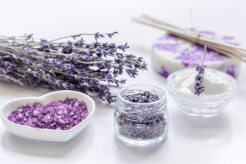 Obraz na płótnie Canvas organic cosmetic with lavender flowers and bath salt on white background