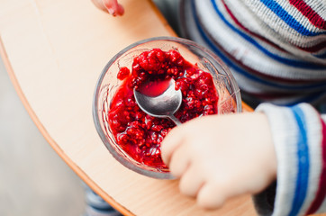 Child eating red jam