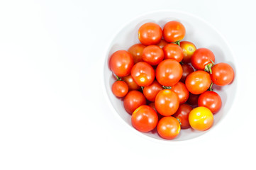 Ripe cherry tomatoes in a bowl on white background