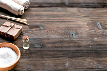 Obraz na płótnie Canvas bathroom salt and natural soap for spa on wooden background mock-up