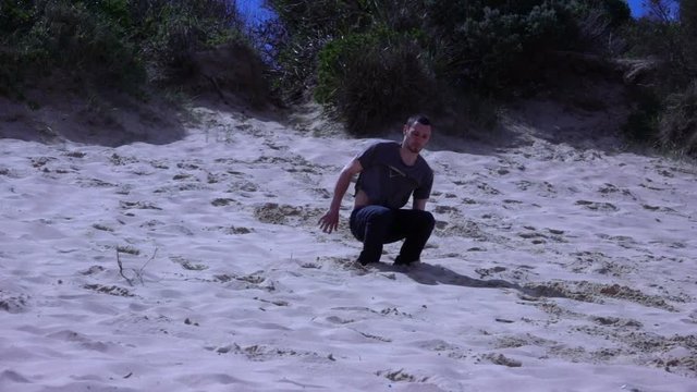Boy Performs a somersault on the beach, slow motion