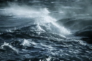 Poster Oceaan golf Big stormy ocean wave. Blue water background