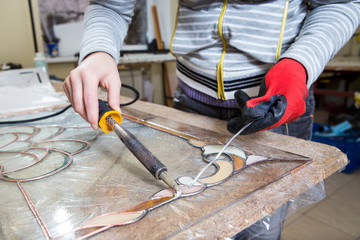 Stained glass maker works with souvenirs