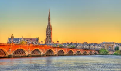 Fotobehang Europa Pont de Pierre bridge and Saint Michel Basilica in Bordeaux, France  © Leonid Andronov