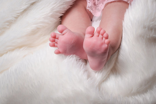 Baby's foot, newborn baby little legs.