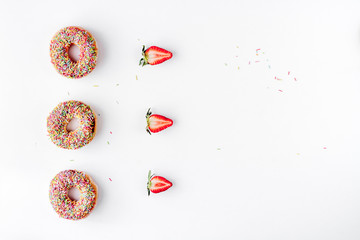 sweet colorful donuts with topping white desk background top view mock-up