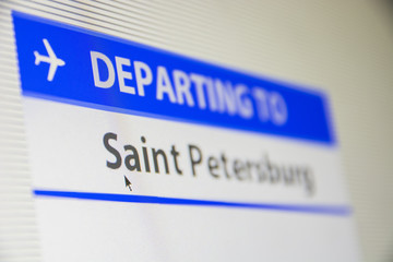 Computer screen close-up of status of flight departing to Saint Petersburg, Russia