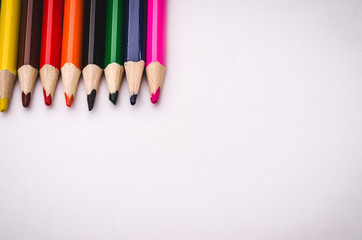 pencils for drawing on paper/pencils lie in a row on paper