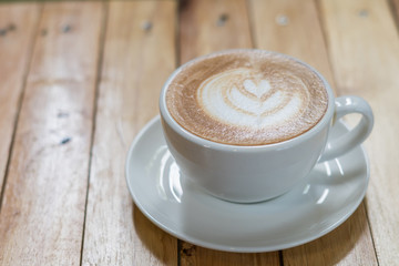 Top view of hot coffee latte art on wood table background
