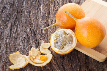 Granadilla, tropical fruits on wooden background (Passiflora ligularis)