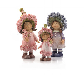 Three decorative dolls made of clay on a white background