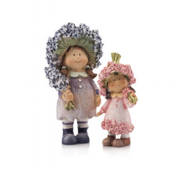 Two decorative dolls made of clay on a white background