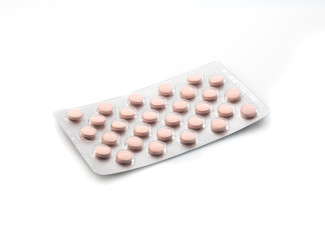 Medicinal pink pills with expired shelf life on a white background. Isolated