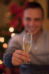 Happy young man with a glass of champagne