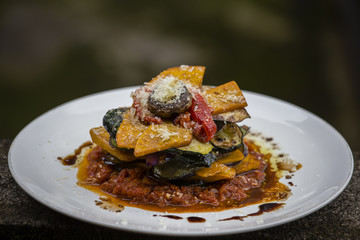 Vegetable stack - pumpkin, zucchini, red capsicum, eggplant and mushroom cooked in a tomato, onion, and garlic sauce topped with parmesan cheese