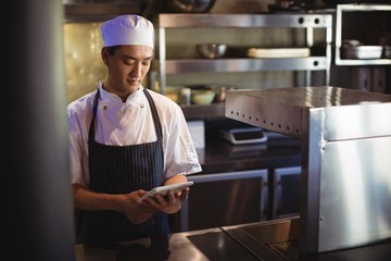 Chef using digital tablet in the commercial kitchen