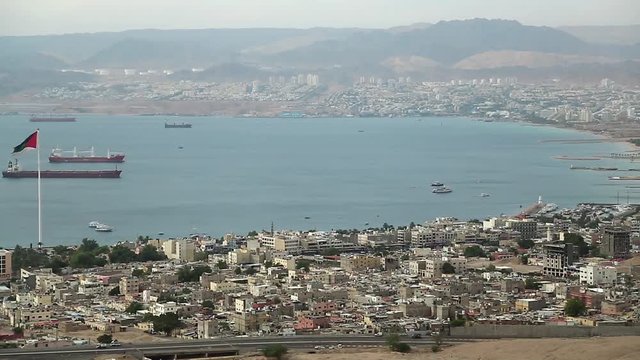 Panorama of Aqaba city in Jordan and Eilat city in Israel. View from mountain in Aqaba city in Jordan. Two city and two country in one video clip