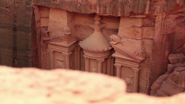Top view of Al Khazneh or Treasury - Nabatean rock-cut temple of Hellenistic period of ancient Petra, originally known to Nabataeans as Raqmu - historical city in Hashemite Kingdom of Jordan