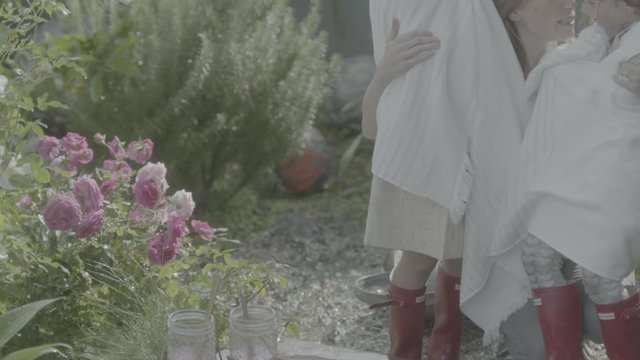Mom gives eskimo kisses to daughters in slow motion
