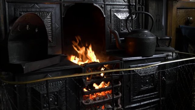 Cast iron traditional coal fired kitchen stove with flickering flames