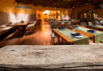 Empty wooden table space platform and blurred resturant or coffee shop background for product display montage
