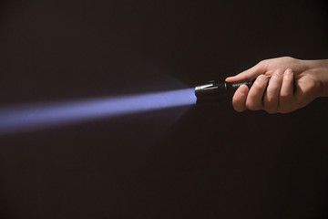 led flashlight in the man's hand from the right side of the frame.